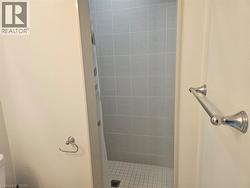 Full bathroom featuring a shower stall and toilet - 