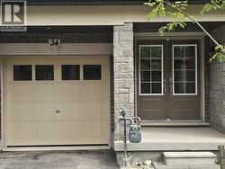 Doorway to property with stone siding, a garage, and french doors - 