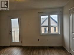 Spare room with dark wood finished floors and a textured ceiling - 