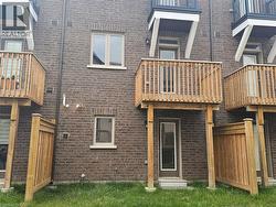 Back of house featuring a balcony and brick siding - 