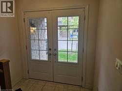 Doorway to outside featuring french doors and tile patterned flooring - 