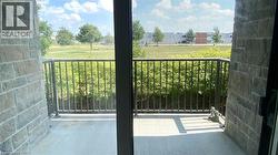 Outdoor balcony featuring a metal railing and a stone-clad exterior wall - 