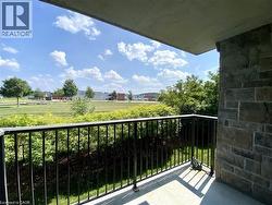 Private balcony featuring a black metal railing and stone exterior wall - 