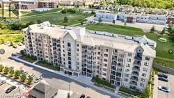 Multi-story residential building featuring a stone and stucco facade, private balconies, and a flat roofline - 