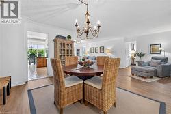 Dining area featuring a circular wood table and an ornate chandelier - 
