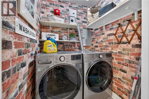Dedicated laundry area featuring modern front-loading washer and dryer units - 1237 North Shore Boulevard Unit# 405, Burlington, ON - Indoor Photo Showing Laundry Room