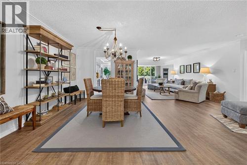 Expansive open-concept living area featuring wood-finish flooring, recessed lighting, and crown molding - 1237 North Shore Boulevard Unit# 405, Burlington, ON - Indoor Photo Showing Living Room