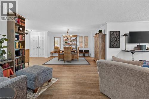 Open-concept living space featuring wood-finish flooring throughout - 1237 North Shore Boulevard Unit# 405, Burlington, ON - Indoor Photo Showing Living Room