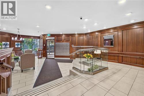 Building lobby featuring wood-paneled walls and light-toned tile flooring - 1237 North Shore Boulevard Unit# 405, Burlington, ON - Indoor