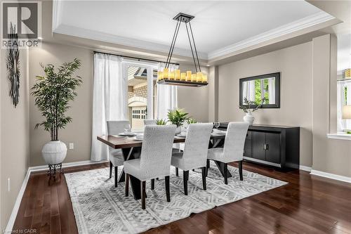 Dining area featuring wood-finish flooring, recessed lighting, and a modern rectangular chandelier - 729 Boughton Crescent, Milton, ON 