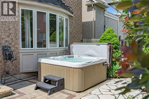 Outdoor spa with stone paver patio - 729 Boughton Crescent, Milton, ON 