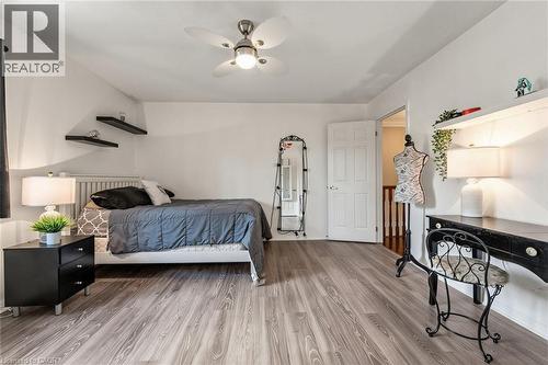 Bedroom featuring wood-finish flooring, a ceiling fan, and white walls - 729 Boughton Crescent, Milton, ON 