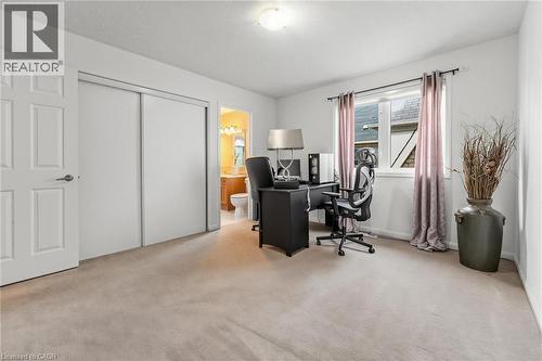 Carpeted room featuring a double-door closet, a white panel door, and a window with a curtain rod - 729 Boughton Crescent, Milton, ON 