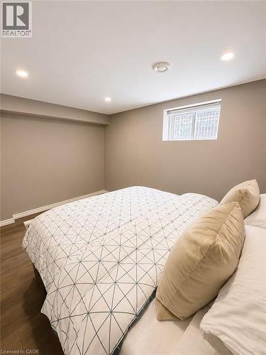 Recessed lighting illuminates this room featuring wood-finish flooring and neutral wall tones - 355 East 36Th Street, Hamilton, ON 