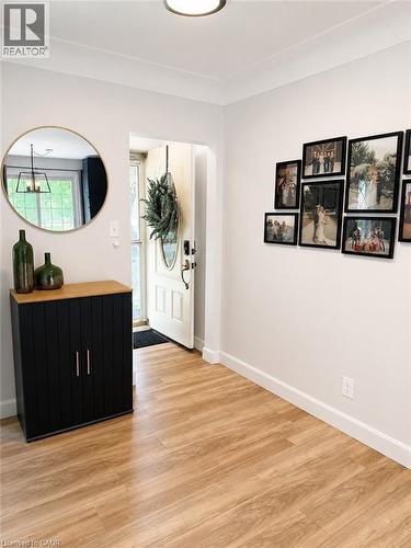 Entryway featuring wood-finish flooring, white baseboards, and a neutral wall color - 355 East 36Th Street, Hamilton, ON 