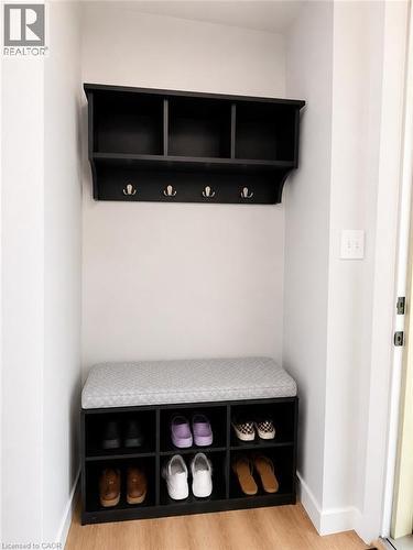 Built-in entryway organization featuring black shelving with storage cubbies and coat hooks - 355 East 36Th Street, Hamilton, ON 