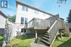 Expansive rear wooden deck featuring multiple levels and privacy lattice - 