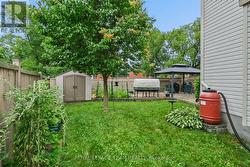Fenced rear yard with shed. - 