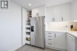 Custom pull-out pantry featuring multiple shelves and drawers, complementing the white shaker-style cabinetry - 