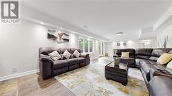 Open-concept living space featuring recessed lighting, wood-finish flooring, and large windows - 