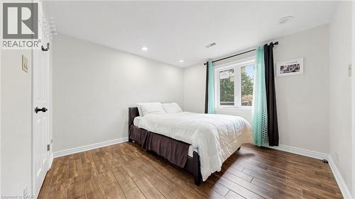 Room featuring wood-finish flooring, white baseboards, and neutral wall paint - 438 Lexington Road, Waterloo, ON 