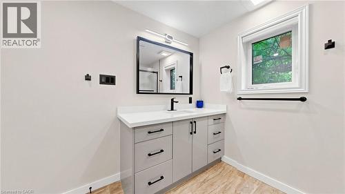Modern vanity featuring a white countertop, undermount sink, and matte black hardware - 438 Lexington Road, Waterloo, ON 