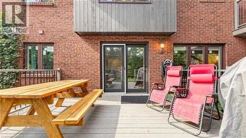 Expansive rear deck featuring composite decking and a black metal railing - 438 Lexington Road, Waterloo, ON 