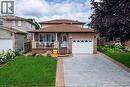 Brick exterior with an attached single-car garage and a paved driveway - 214 Merrilee Crescent, Hamilton, ON 