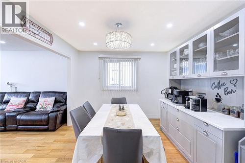 Dining area featuring recessed lighting, a modern chandelier, and wood-finish flooring - 214 Merrilee Crescent, Hamilton, ON 