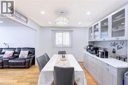 Dining area featuring recessed lighting, a modern chandelier, and wood-finish flooring - 