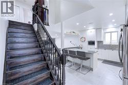 Dark wood staircase with carpeted treads and classic balusters - 