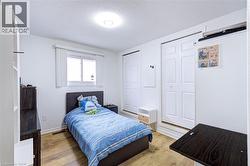 Bright interior space featuring wood-finish flooring and white walls - 