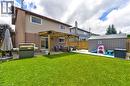 Expansive backyard featuring a lush lawn, concrete patio, and a built-in pergola - 214 Merrilee Crescent, Hamilton, ON 