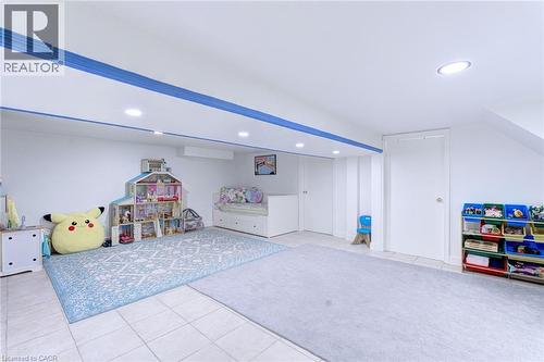 Spacious recreational room featuring recessed lighting, white walls, and a tiled floor - 214 Merrilee Crescent, Hamilton, ON 