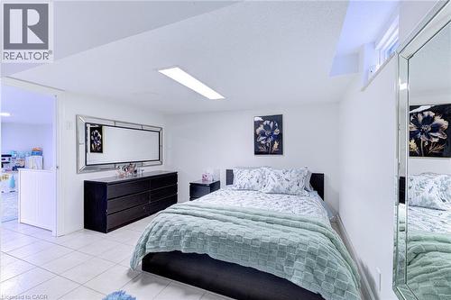 Bedroom featuring neutral wall paint, tile flooring, and a recessed window - 214 Merrilee Crescent, Hamilton, ON 