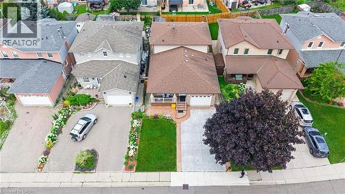 Multi-story property with a brown shingle roof, beige siding, and a covered porch - 214 Merrilee Crescent, Hamilton, ON 