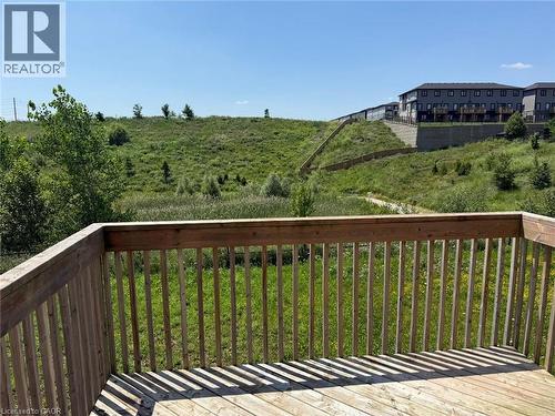 Exterior wood deck with a slatted railing overlooking a natural green hillside - 63 Ridge Road Unit# Upper, Cambridge, ON 