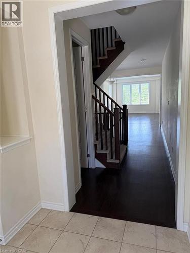 Open concept entryway with tile flooring transitioning to dark wood-finish flooring - 63 Ridge Road Unit# Upper, Cambridge, ON 