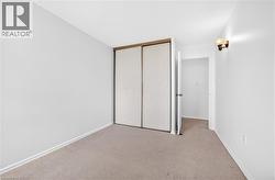 Wall-to-wall carpeting and white walls with baseboards - 
