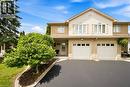 Two-story property featuring a brick and siding exterior, a two-car garage, and a paved driveway - 16 Scottacres Boulevard, Caledonia, ON  - Outdoor With Facade 