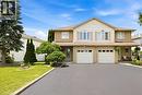 Two-story residence featuring brick and siding facade, dual garage doors, and a covered porch entry - 16 Scottacres Boulevard, Caledonia, ON  - Outdoor With Facade 
