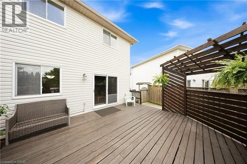 Expansive wood deck with a built-in pergola featuring slatted wood panels - 16 Scottacres Boulevard, Caledonia, ON - Outdoor With Exterior