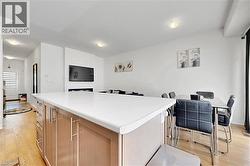 Spacious kitchen island with a light-toned countertop, wood-finish cabinetry, and stainless steel hardware - 