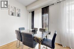 Dining area featuring wood-finish flooring and white baseboards - 