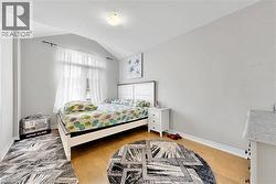 Bedroom featuring a vaulted ceiling and a large window - 
