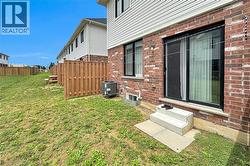 Brick exterior with a sliding glass door and concrete steps - 