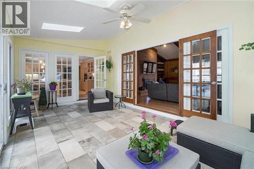 Sunroom with natural light and access to backyard patio - 18 Stonegate Drive, Hamilton, ON 