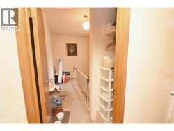 Hallway leading to basement stairs - 