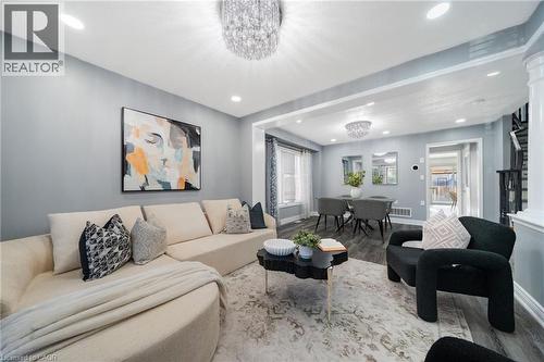 Open-concept living area with gray wall paint and wood-finish flooring - 151 Baldwin Drive, Cambridge, ON 