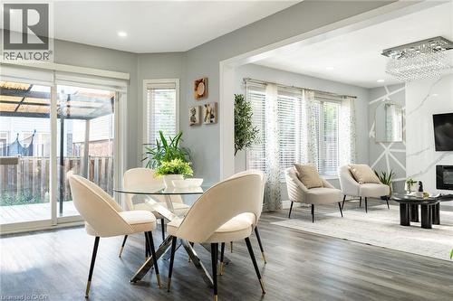 Open-concept living space featuring wood-finish flooring and recessed lighting - 151 Baldwin Drive, Cambridge, ON 